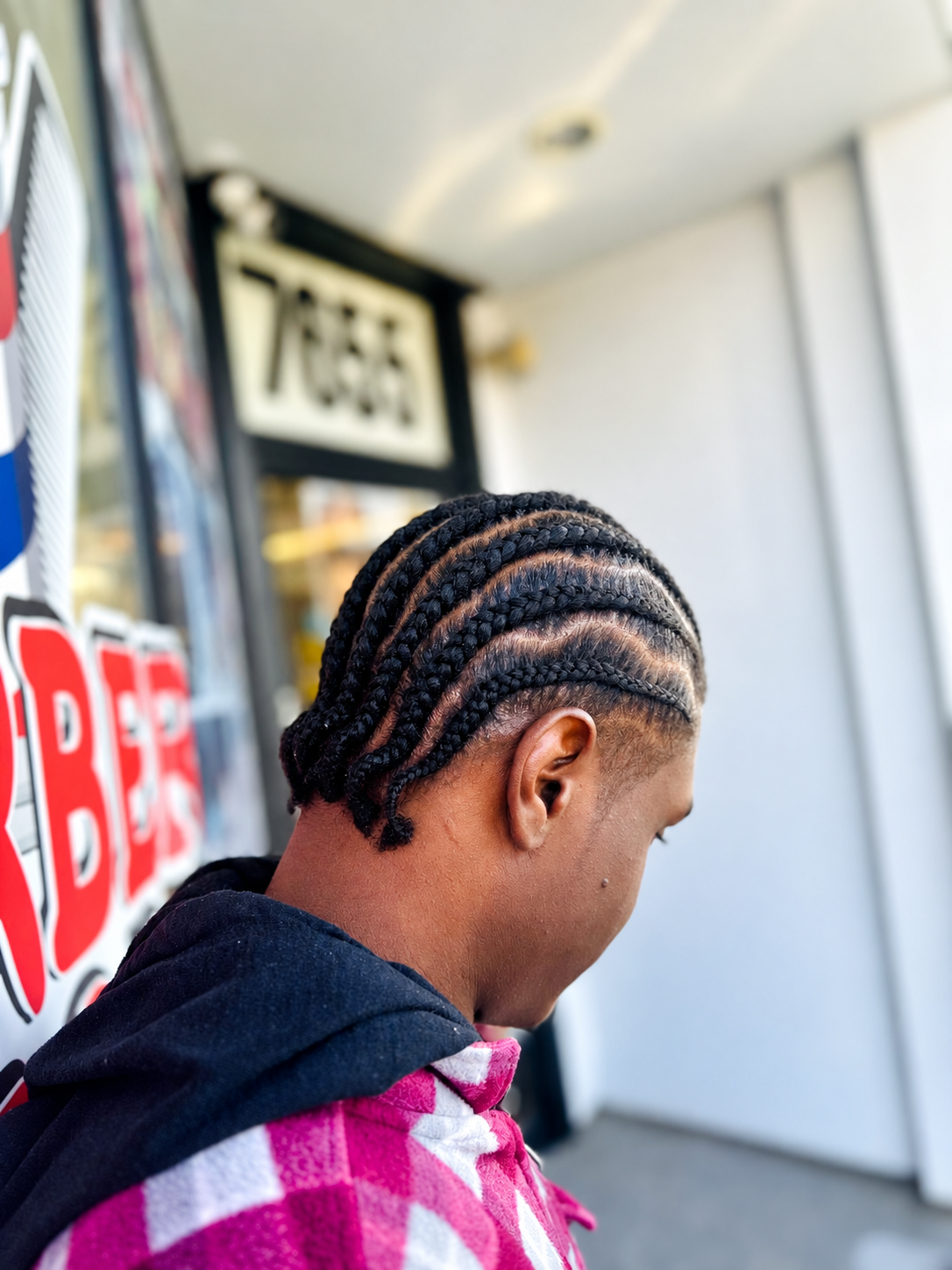 Straight cornrows rear view at AD Blades and Braids